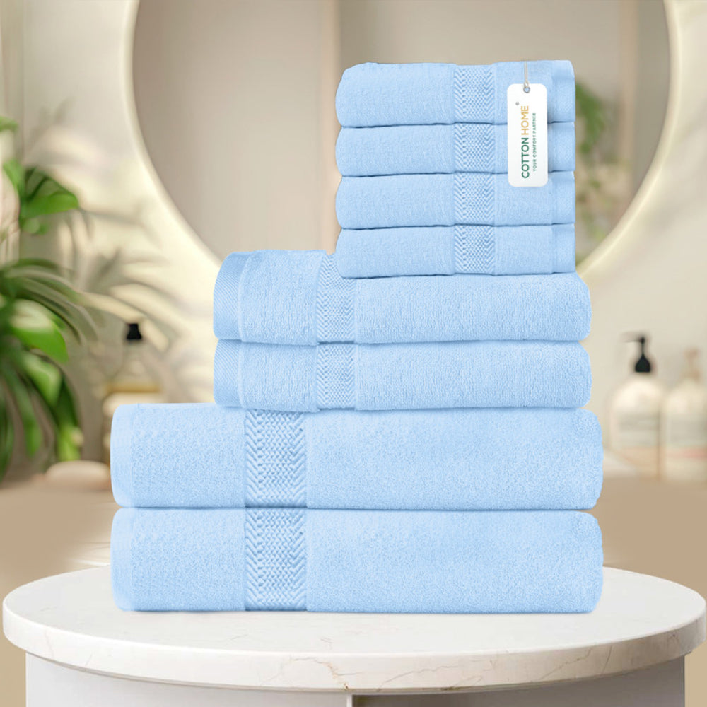 طقم مناشف قطنية فاخرة من كوتون هوم، مكون من 8 قطع: 4 مناشف للوجه (30×30 سم)، منشفتان لليدين (40×70 سم)، منشفتان للاستحمام (70×140 سم)، وزن 600 غرام/متر مربع، سريع الجفاف ومتين.
