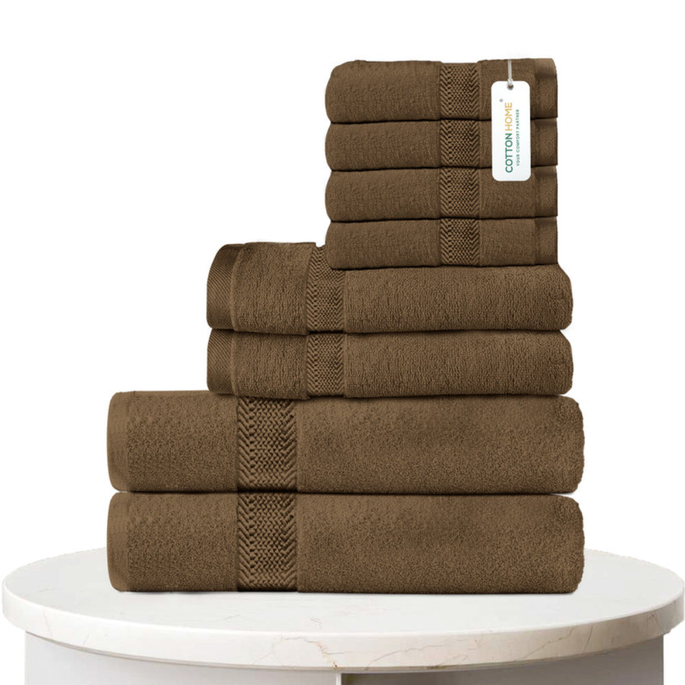 طقم مناشف قطنية فاخرة من كوتون هوم، مكون من 8 قطع: 4 مناشف للوجه (30×30 سم)، منشفتان لليدين (40×70 سم)، منشفتان للاستحمام (70×140 سم)، وزن 600 غرام/متر مربع، سريع الجفاف ومتين.