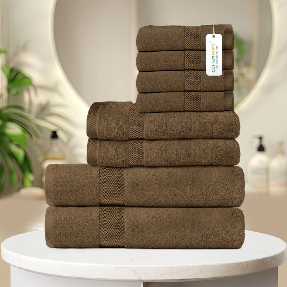 طقم مناشف قطنية فاخرة من كوتون هوم، مكون من 8 قطع: 4 مناشف للوجه (30×30 سم)، منشفتان لليدين (40×70 سم)، منشفتان للاستحمام (70×140 سم)، وزن 600 غرام/متر مربع، سريع الجفاف ومتين.