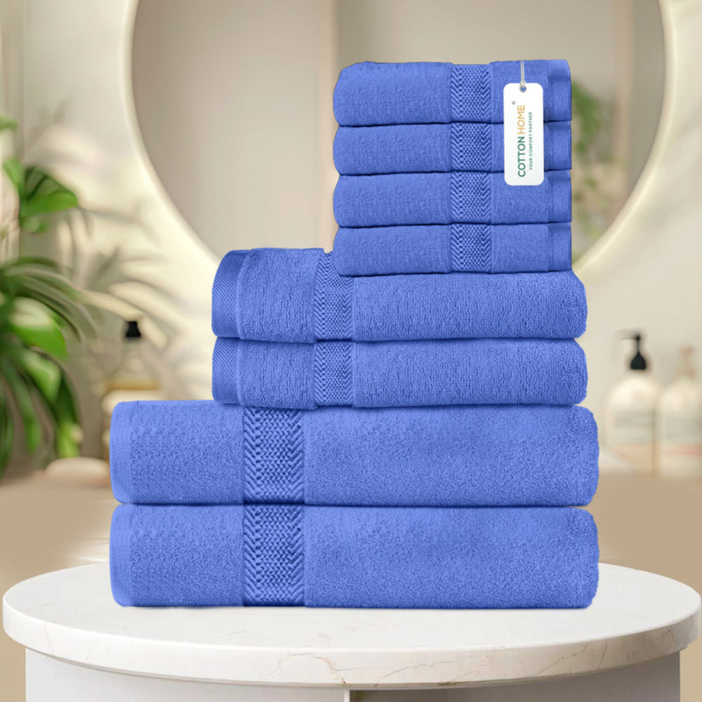 طقم مناشف قطنية فاخرة من كوتون هوم، مكون من 8 قطع: 4 مناشف للوجه (30×30 سم)، منشفتان لليدين (40×70 سم)، منشفتان للاستحمام (70×140 سم)، وزن 600 غرام/متر مربع، سريع الجفاف ومتين.
