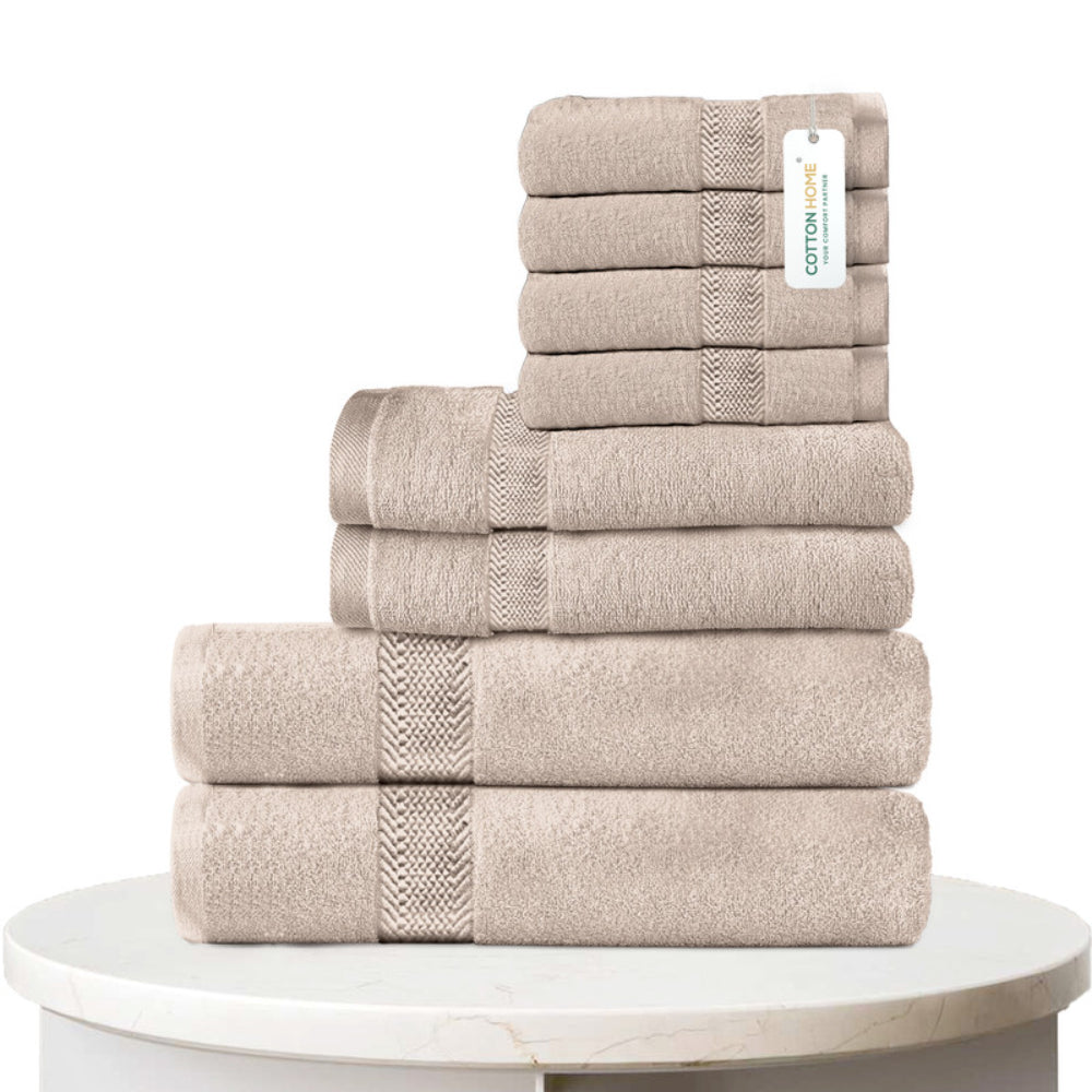 طقم مناشف قطنية فاخرة من كوتون هوم، مكون من 8 قطع: 4 مناشف للوجه (30×30 سم)، منشفتان لليدين (40×70 سم)، منشفتان للاستحمام (70×140 سم)، وزن 600 غرام/متر مربع، سريع الجفاف ومتين.