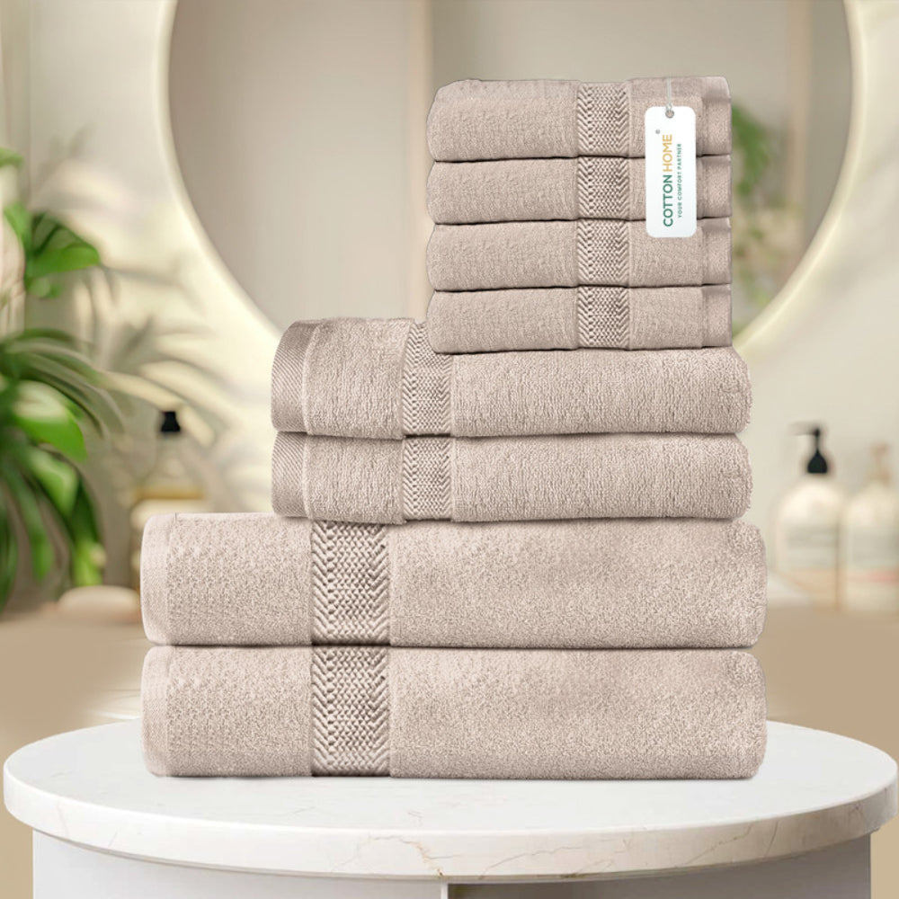 طقم مناشف قطنية فاخرة من كوتون هوم، مكون من 8 قطع: 4 مناشف للوجه (30×30 سم)، منشفتان لليدين (40×70 سم)، منشفتان للاستحمام (70×140 سم)، وزن 600 غرام/متر مربع، سريع الجفاف ومتين.